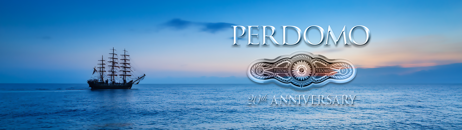Silhouette of a tall sailing ship on a peaceful ocean at sunset with colorful sky, featuring the Perdomo 20th Anniversary logo overlay.
