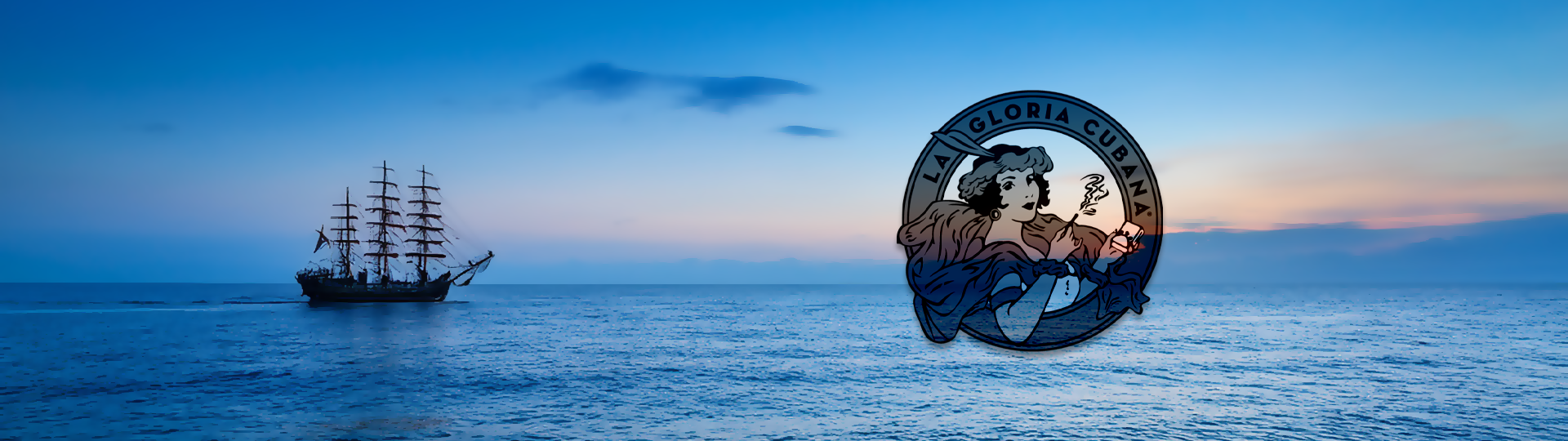 Silhouette of a tall sailing ship on a peaceful ocean at sunset with colorful sky, featuring the La Gloria Cubana logo overlay.
