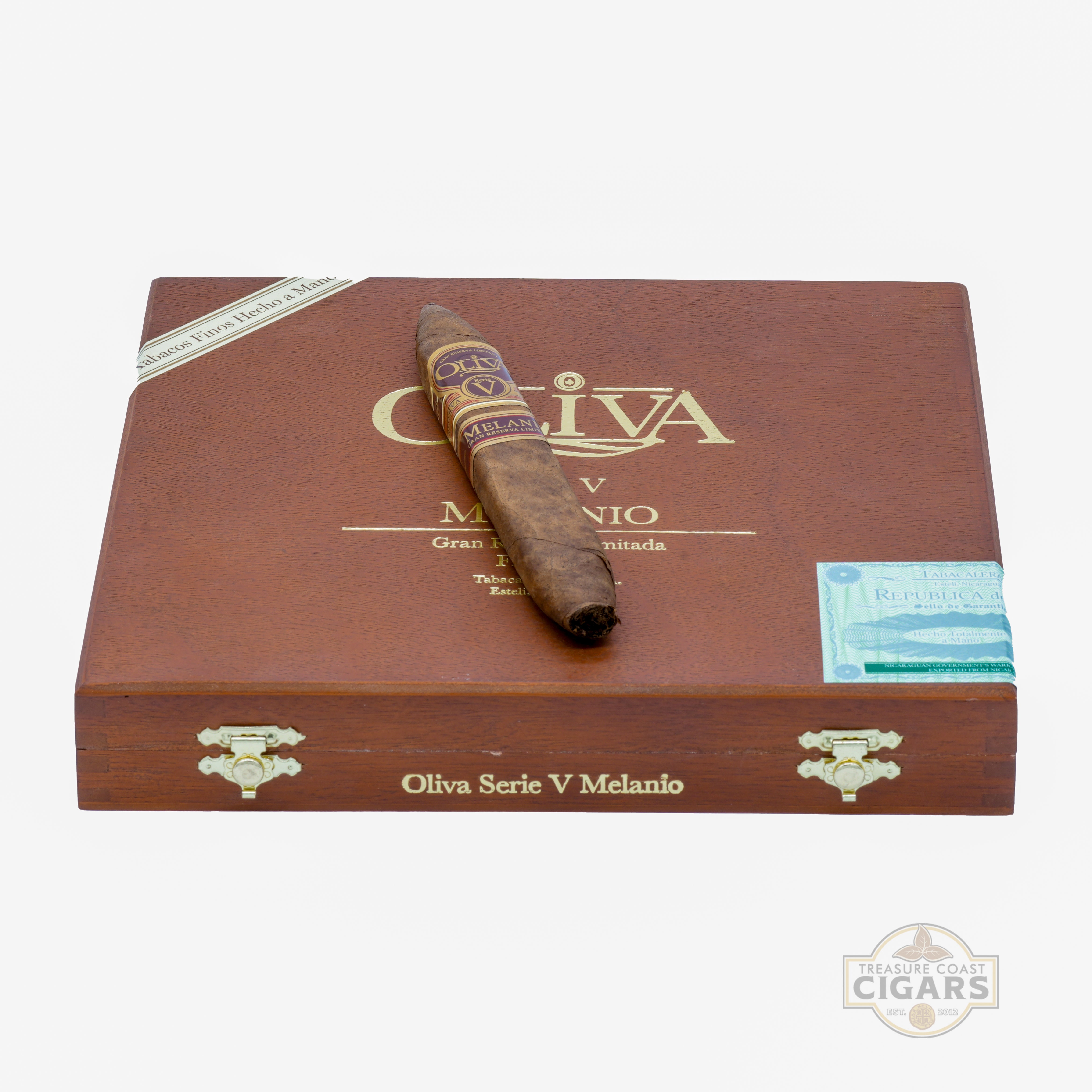 Box of Oliva Serie V Melanio cigars with a single cigar on top against a white background