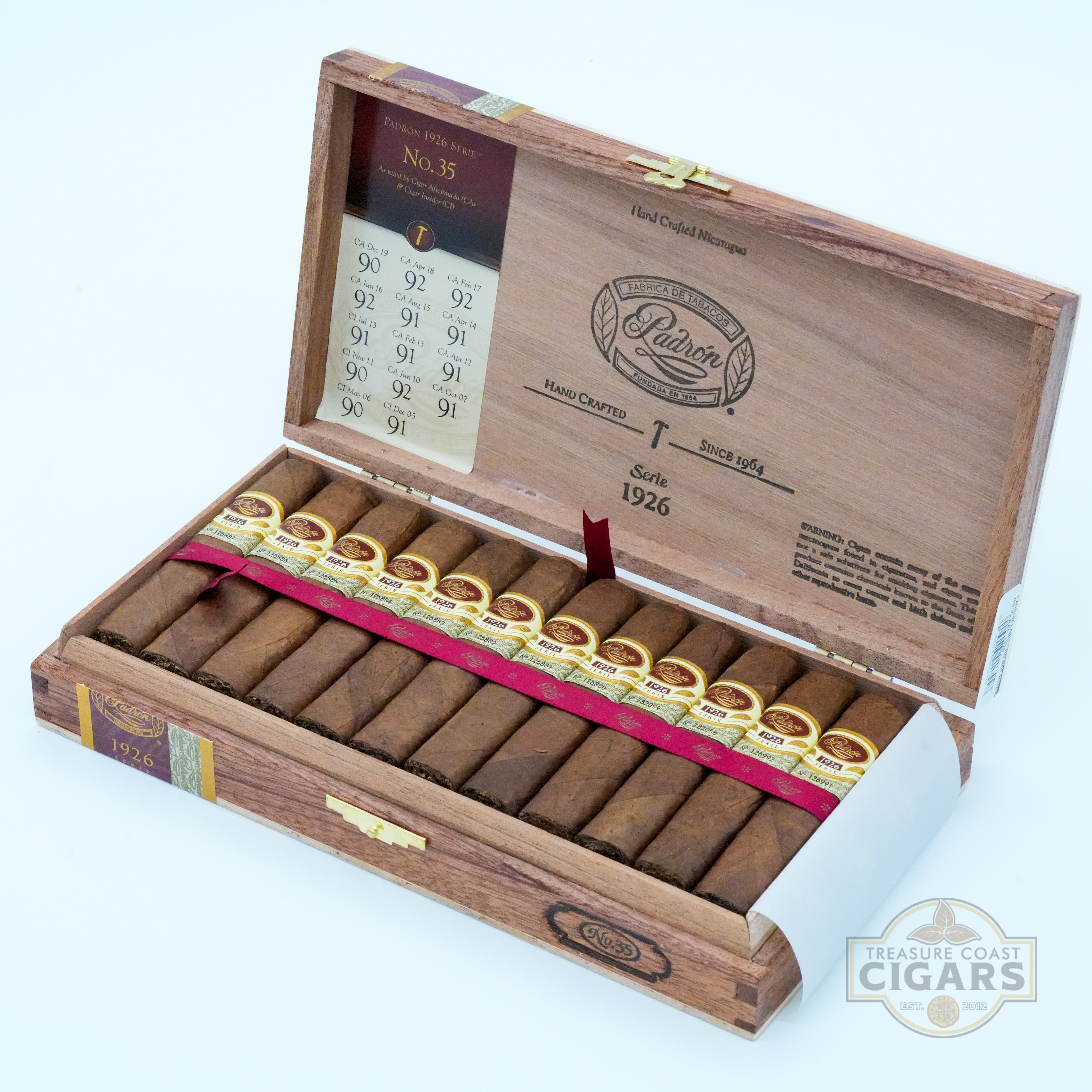Open wooden box of cigars with cigars inside on a white background