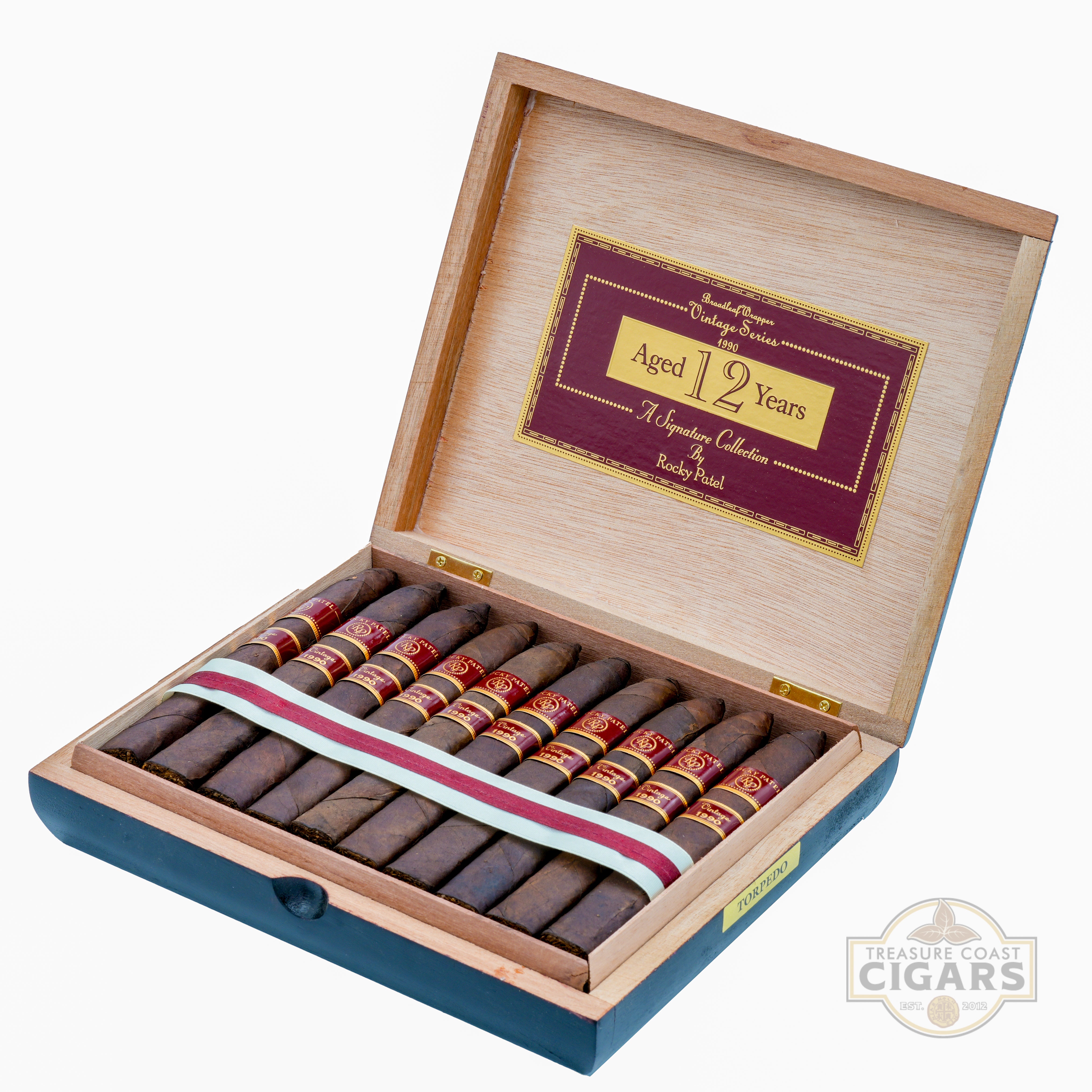 Open wooden cigar box with cigars inside, featuring a Treasure Coast Cigars logo.