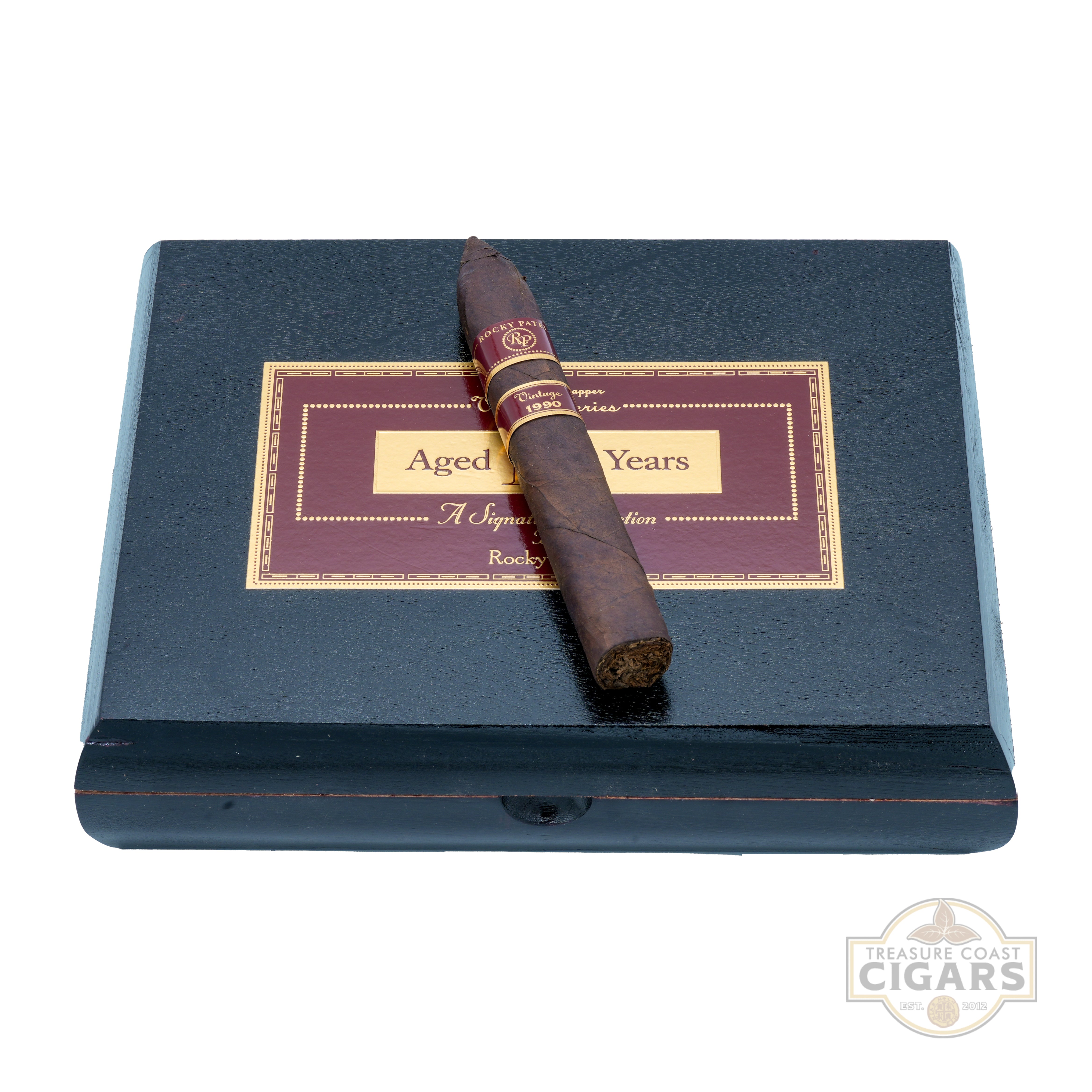 Cigar on a black box with a label, Treasure Coast Cigars logo visible