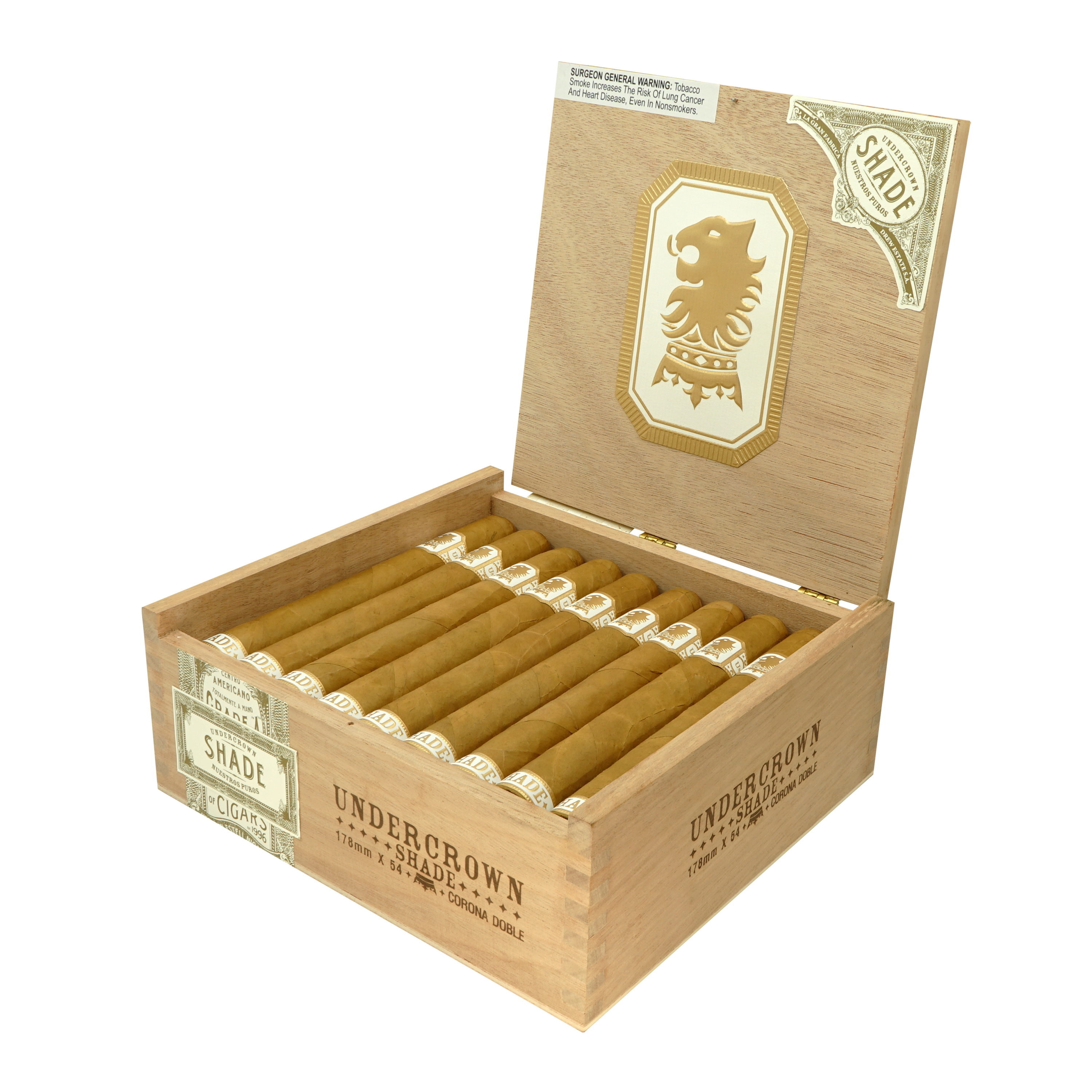 Open wooden box of Undercrown Shade cigars by Drew Estate, showing neatly arranged Corona Doble cigars with light Connecticut wrappers. The box lid features a gold lion logo and branding details.
