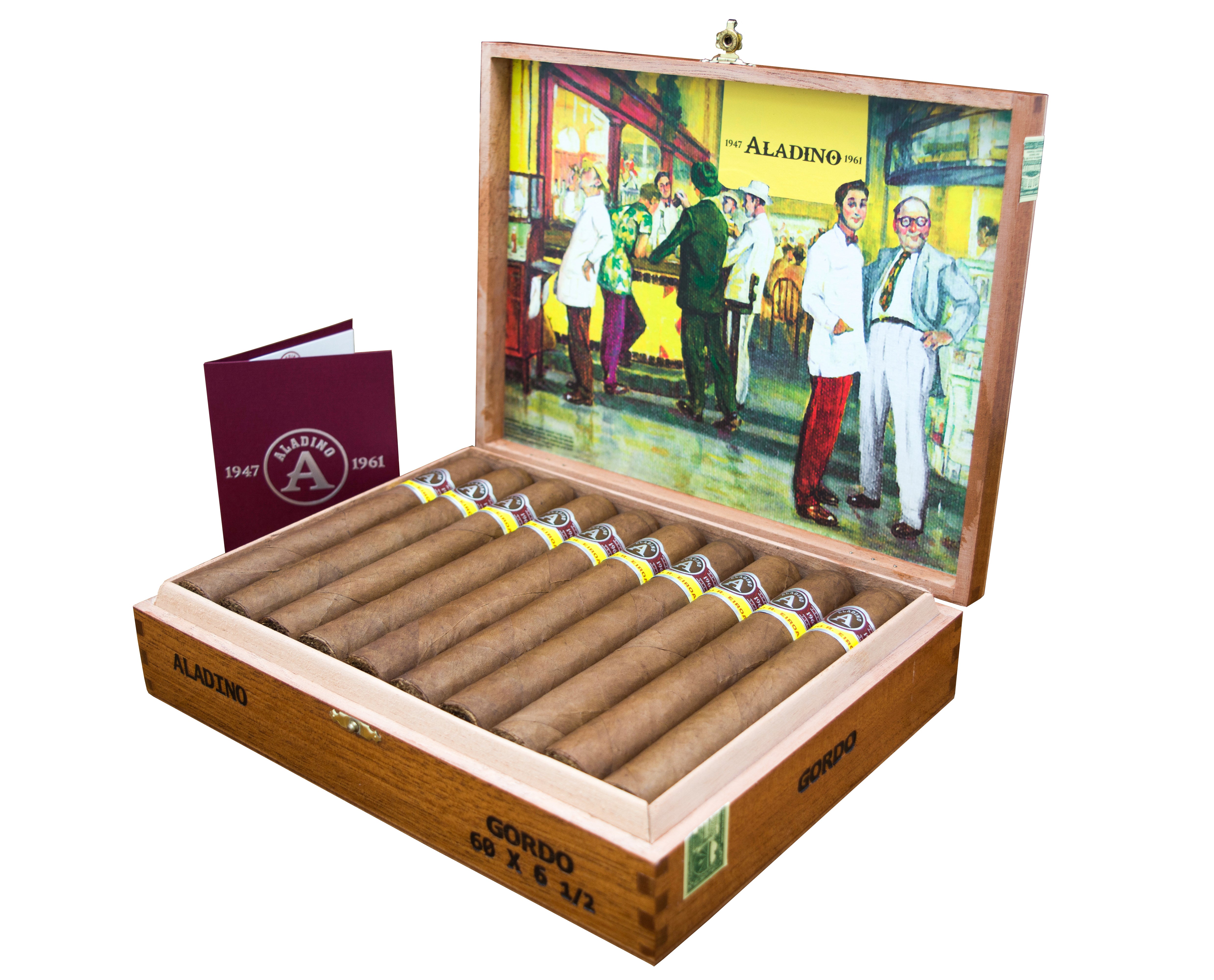 A wooden cigar box labeled "ALADINO GORDO" is open, revealing a row of neatly arranged cigars with yellow and black bands. The inside lid features a colorful illustration of people in a vintage shop, with the "ALADINO 1961" logo prominently displayed. Next to the box is a maroon booklet or folder with the Aladino logo and the year "1947-1961" printed on it. 