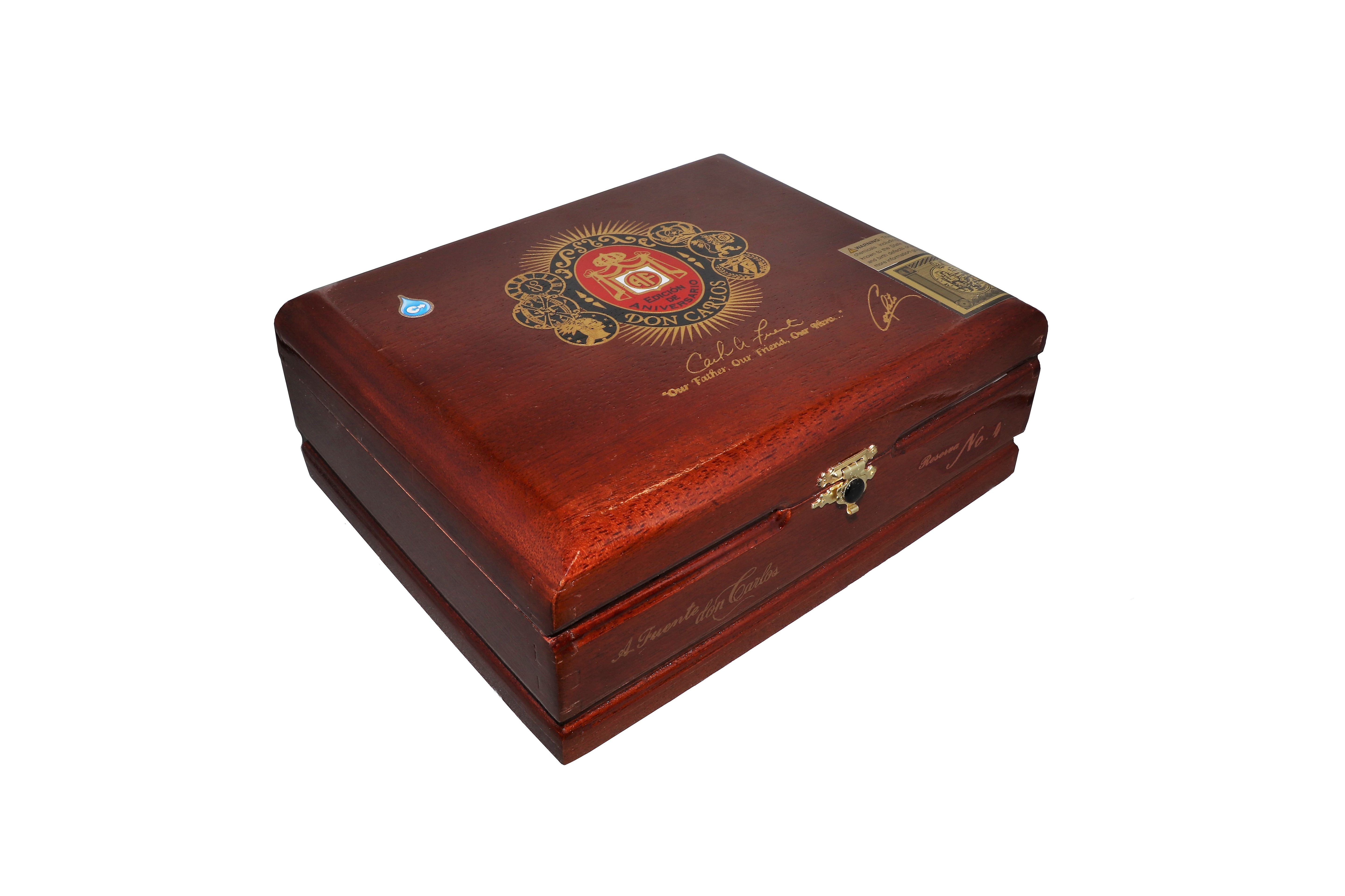 Wooden cigar box with decorative emblem on a white background