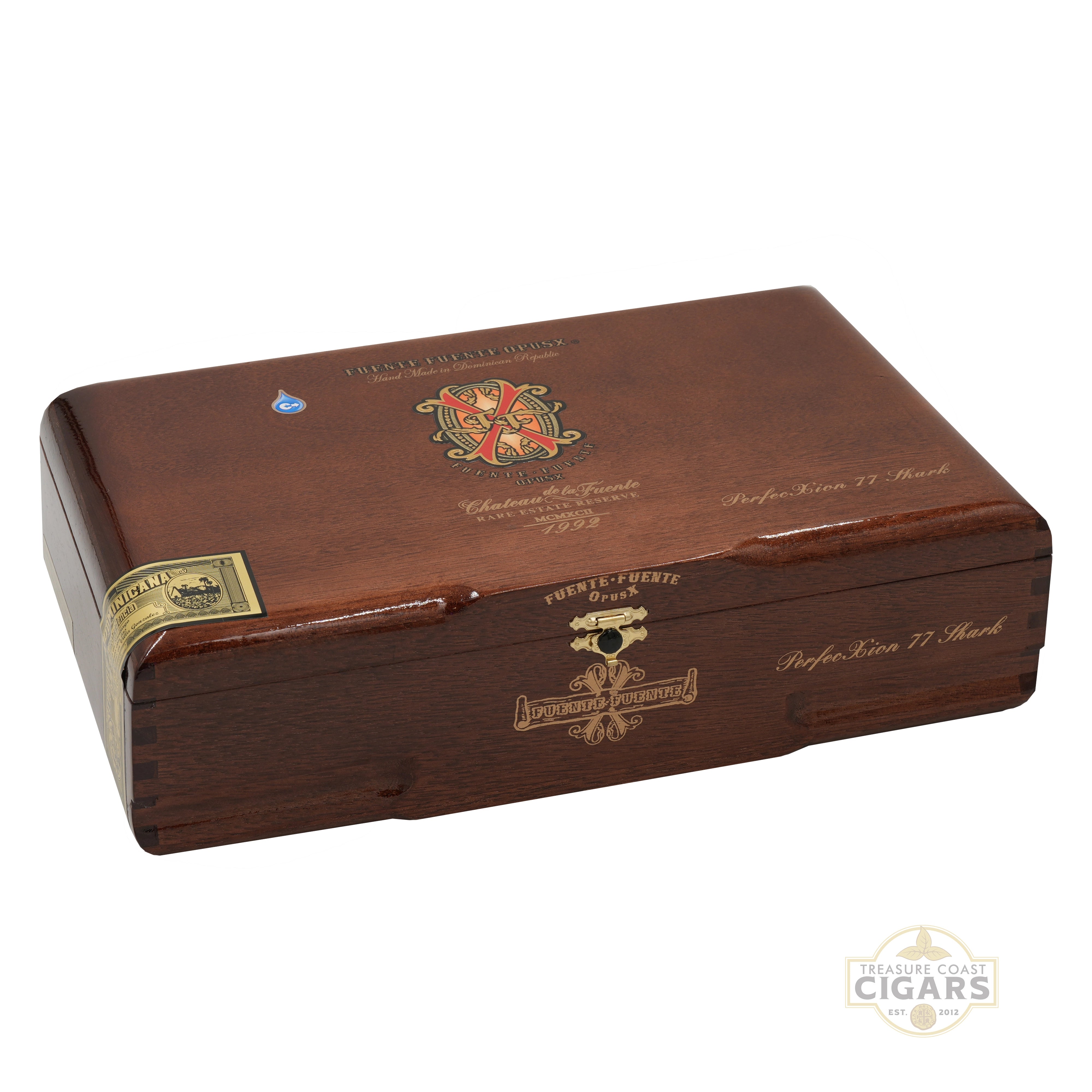 A polished dark brown wooden cigar storage box with gold and multicolor crest engravings, shown at an angle on a white background.