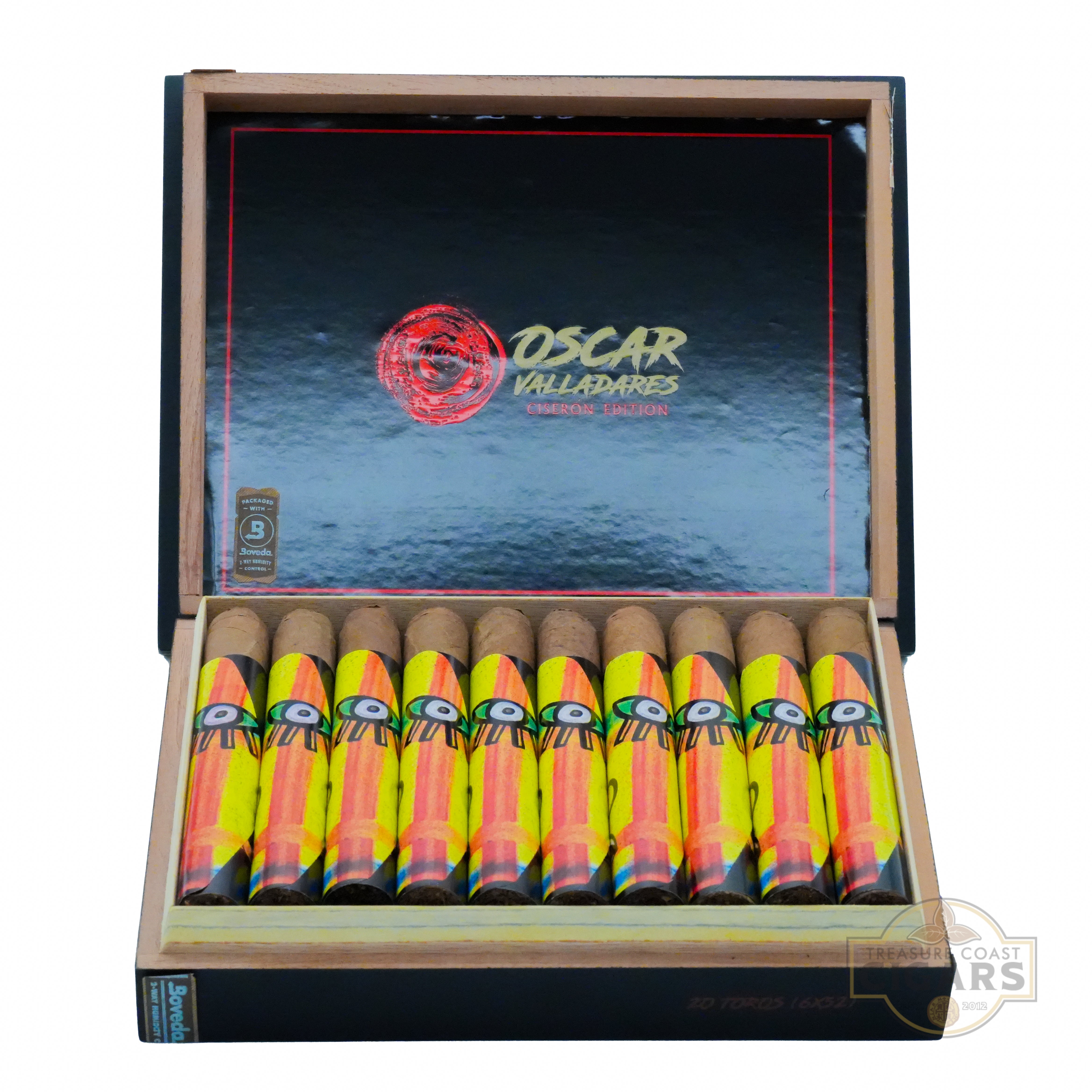 A wooden cigar box open to reveal a collection of premium cigars. The interior is lined with a black and red design in a wave pattern, and the lid displays the text "OSCAR VALLADARES" in bold gold brush font letters. The cigars are arranged in two rows, each wrapped with a colorful band featuring a bold eye design in green, yellow, orange, and black hues. 