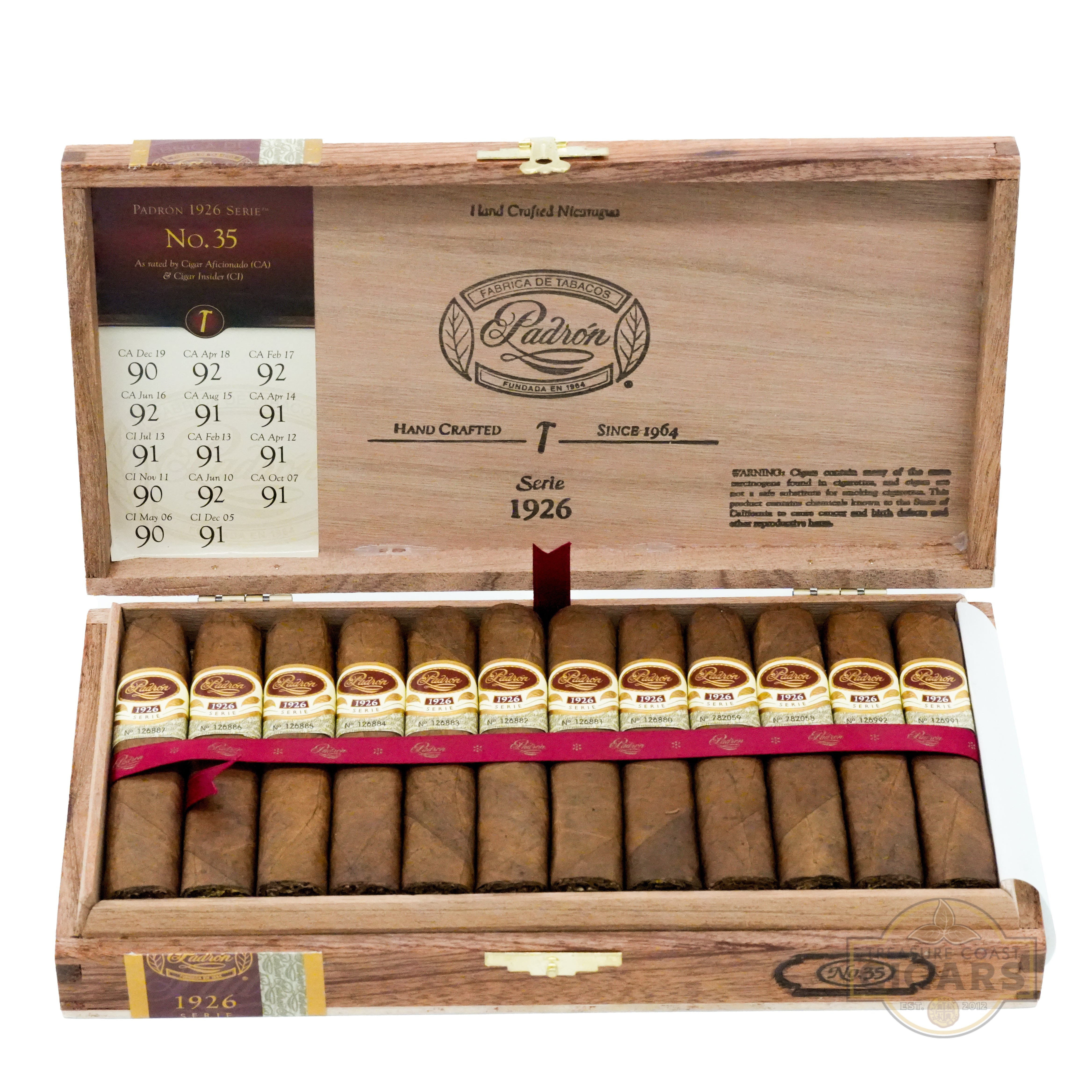 Open wooden box of Padron cigars with cigars inside on a white background