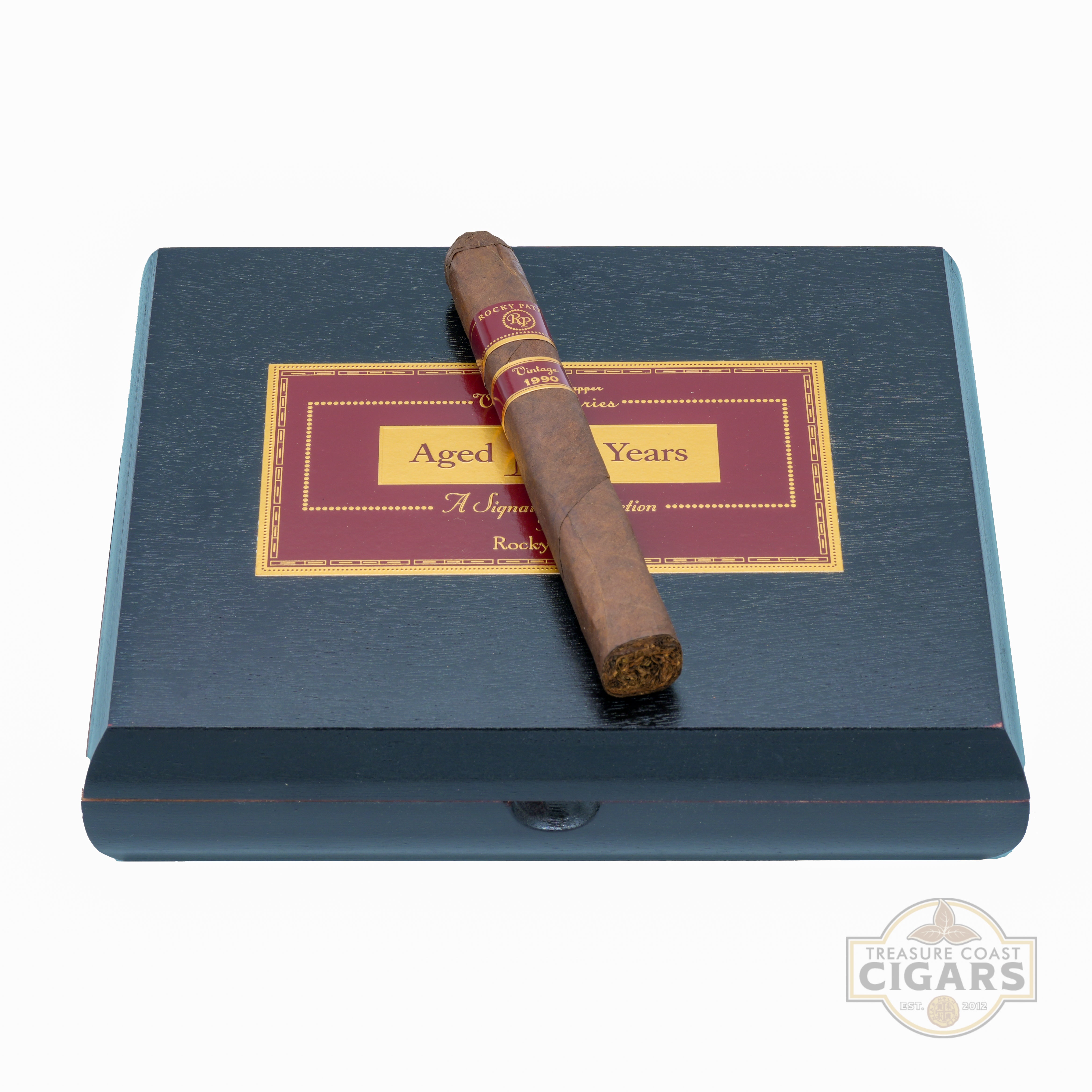 Cigar on a black box with a visible brand logo.