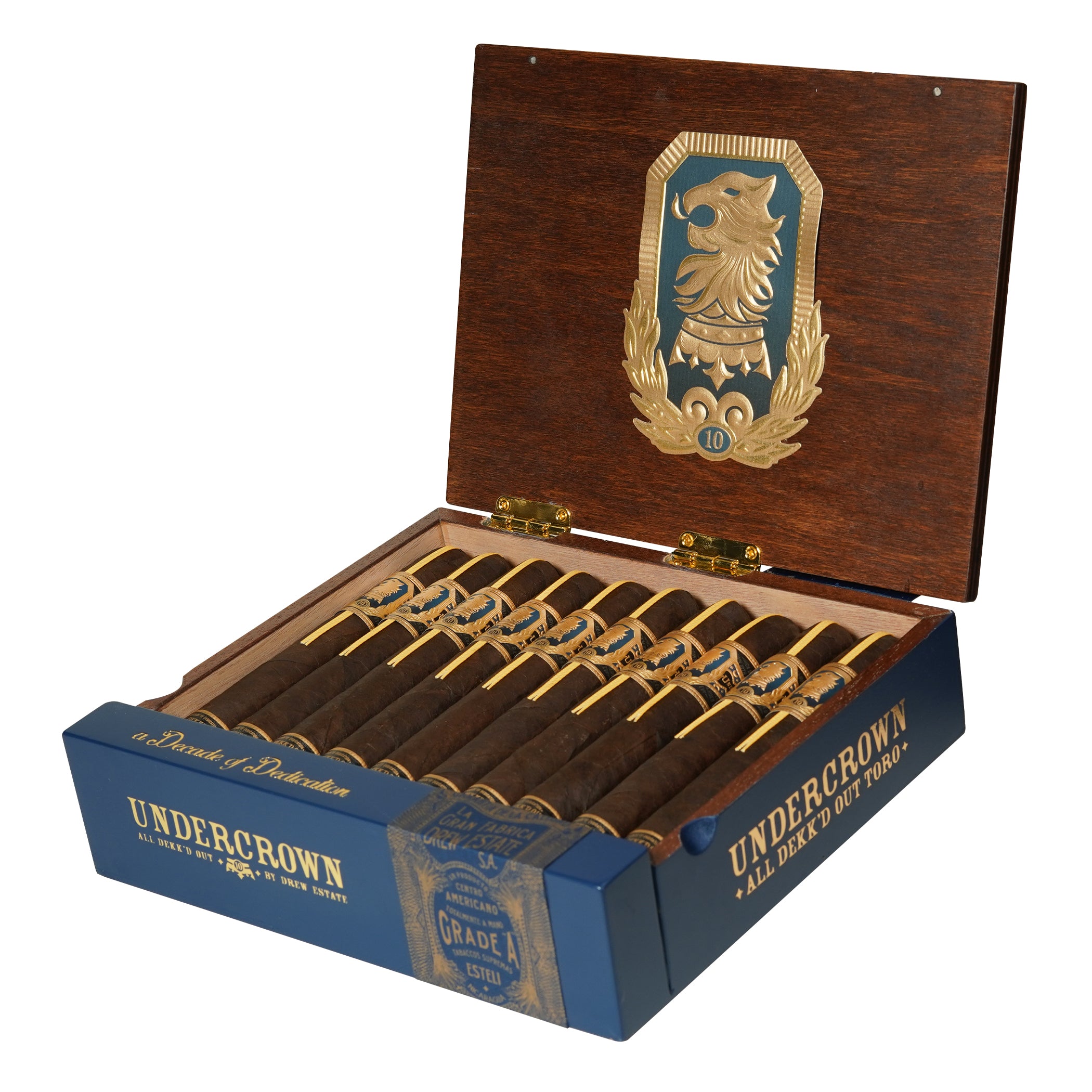 Open wooden box of Undercrown 10 Toro cigars with a decorative emblem on a white background