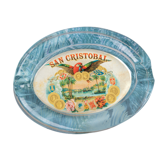 Decorative crystal ashtray with 'San Cristobal' branding featuring a parrot and tropical elements on a blue background.